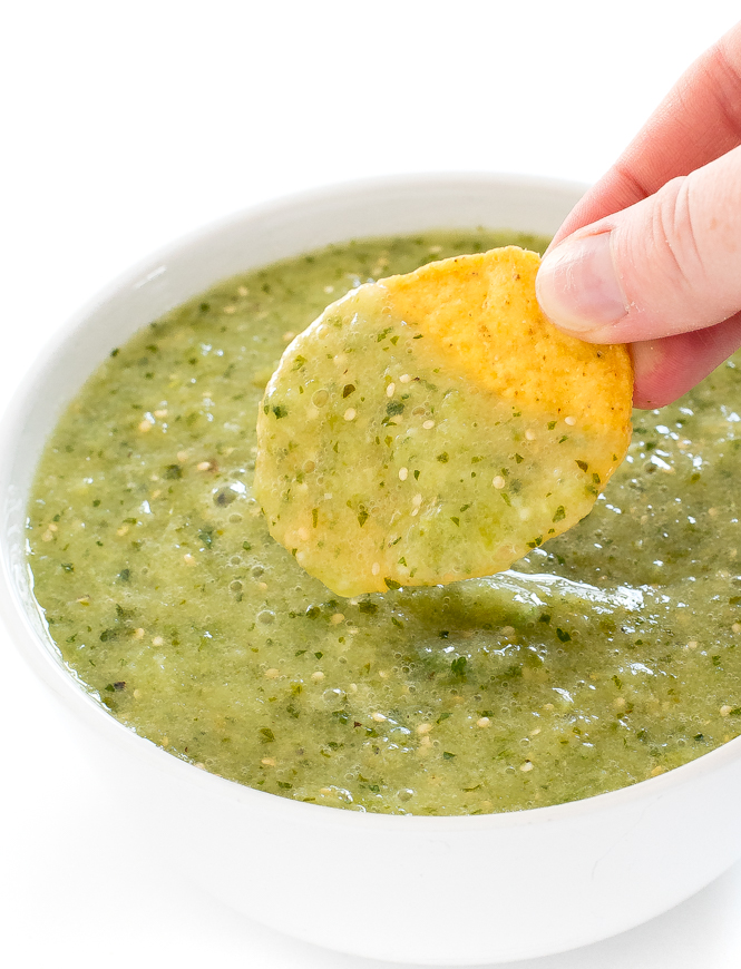 Dipping tortilla chip in tomatillo salsa