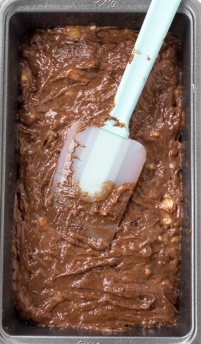 Chocolate Banana Bread Batter | chefsavvy.com Batter in a bread tin with a spatula.