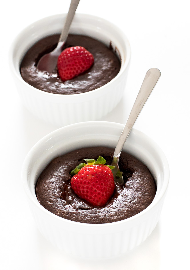 molten lava cake topped with strawberry in white ramekin