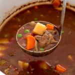 Crockpot Vegetable Beef Soup bring scooped out of the slow cooker with a ladle | chefsavvy.com