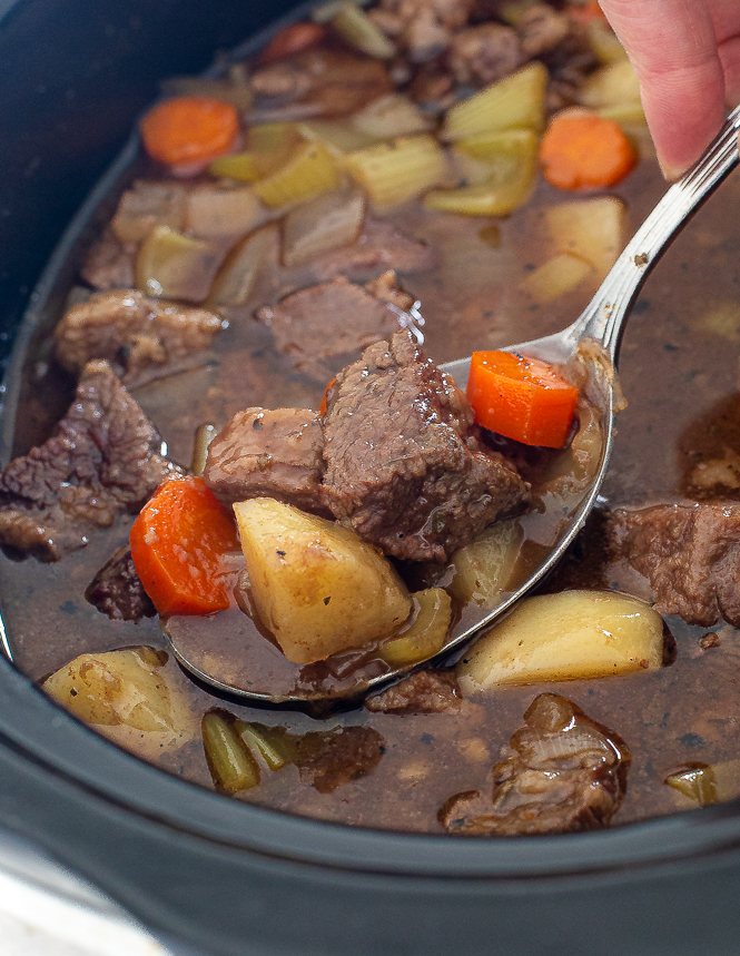 spooning Guinness stew out of the slow cooker