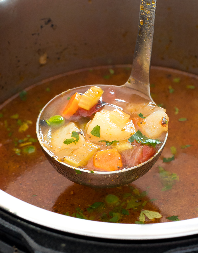 ladling out vegetable soup out of pressure cooker