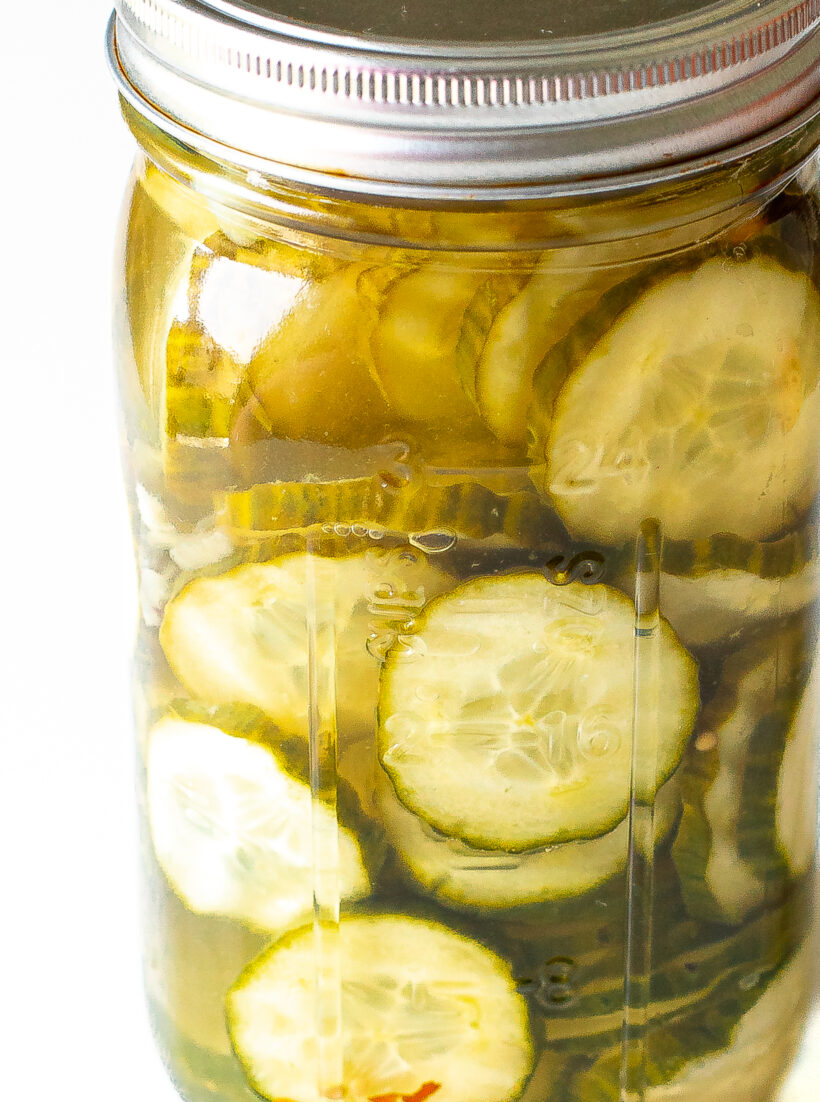 Pickle slices in a jar with brine.