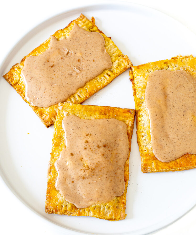 3 pumpkin pie pop tarts on a white plate.