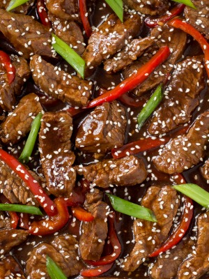 closeup of Sesame Beef with peppers and green onions and sesame seeds