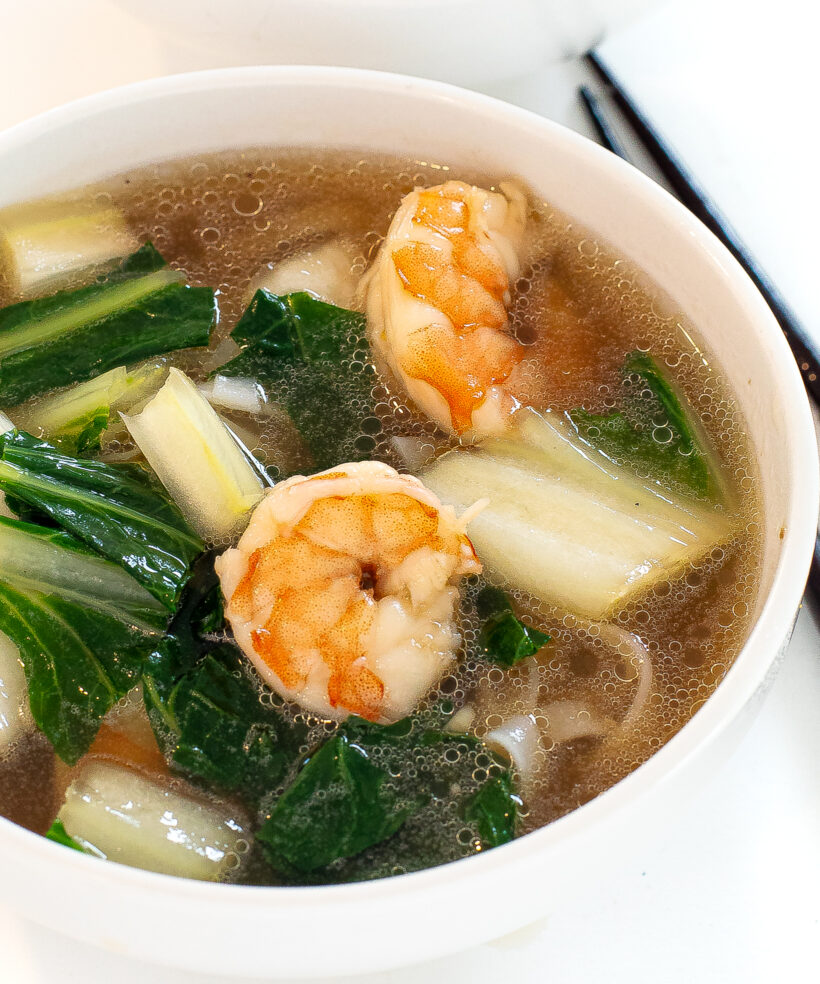 shrimp, bok choy and broth in white bowl