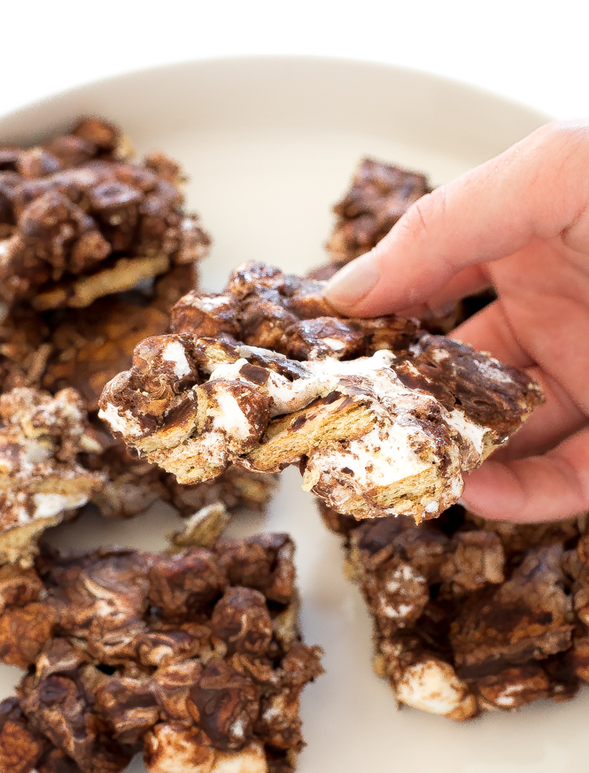 The Best Smore's Bars! | chefsavvy.com A hand holding a smores bar