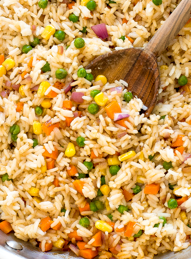close up shot of rice with vegetables in skillet