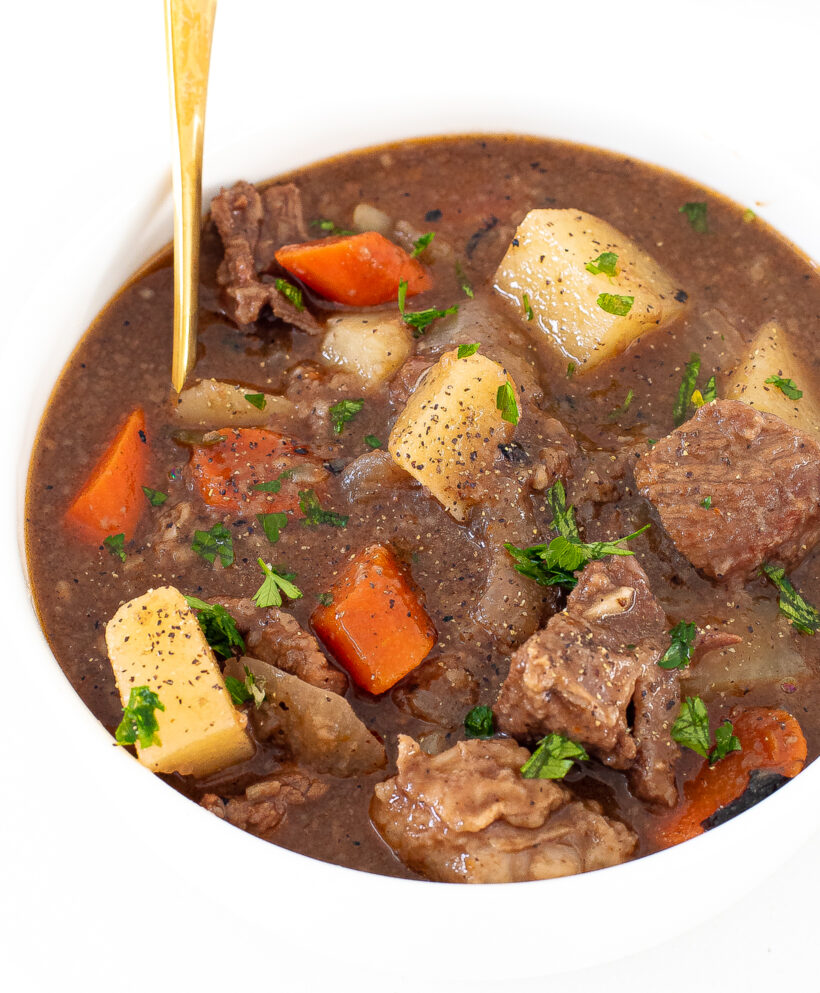 tender beef stew with carrots, potatoes and sprinkled with salt, pepper and fresh parsley