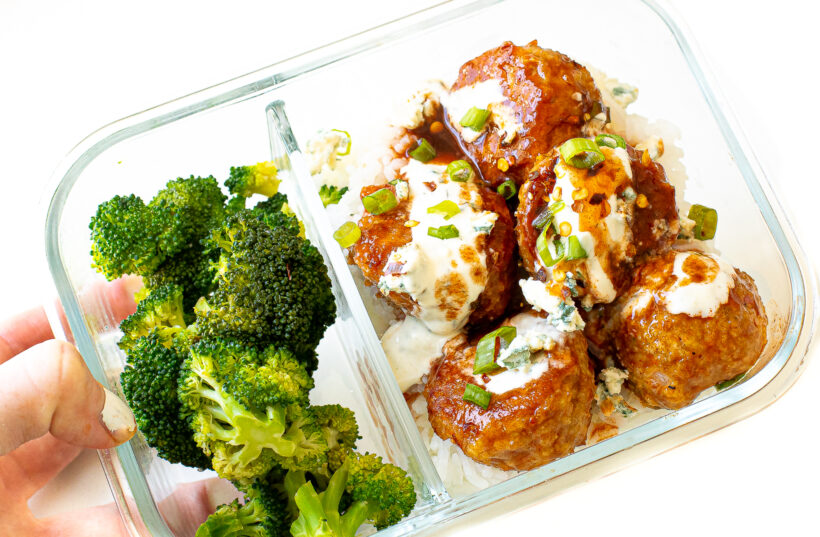 Meatballs and broccoli in a glass meal prep container.