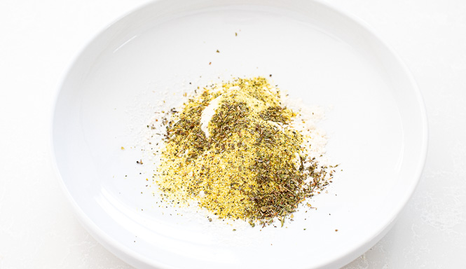 Flour and seasonings in a shallow white bowl. 
