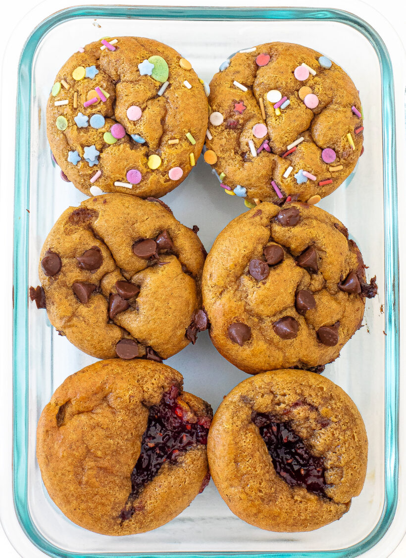 Mini muffins in a glass container with different toppings. 