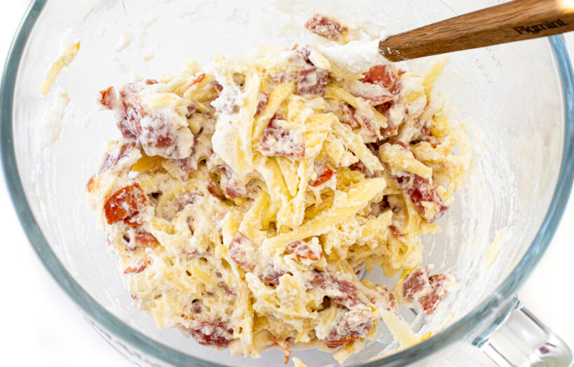 folding meats and cheese into whipped egg mixture