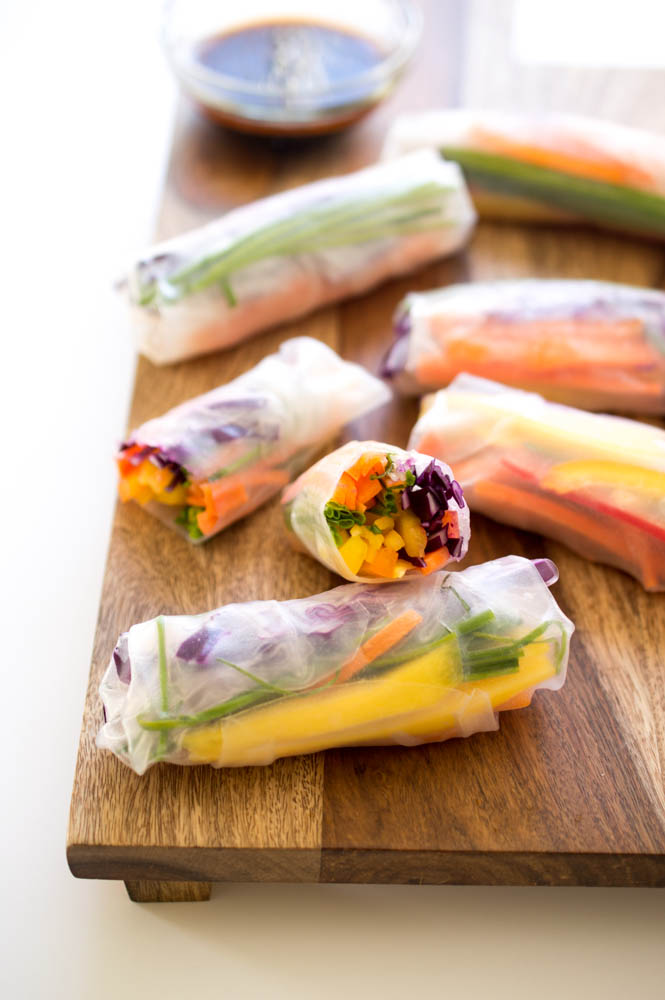 Vegetarian Rainbow Vegetable Spring Rolls on wooden cutting board