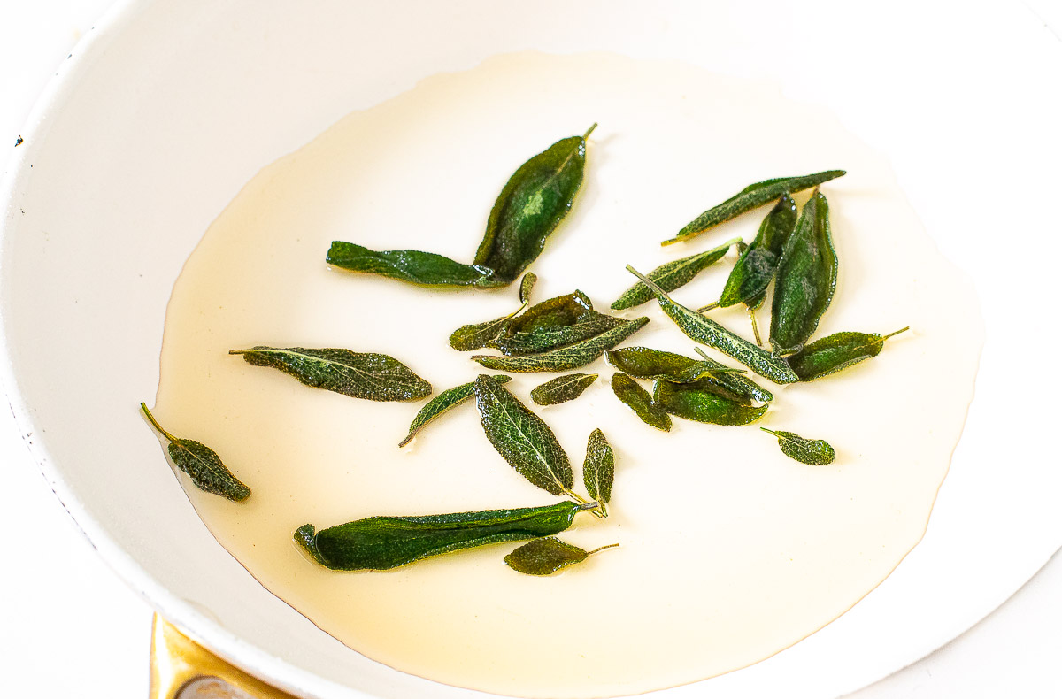 pan frying sage leaves in oil