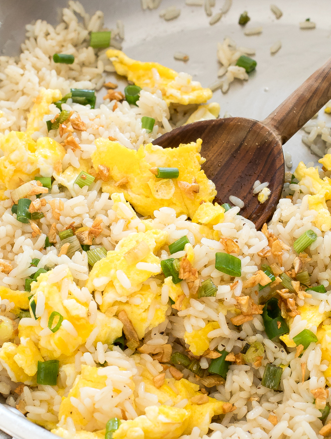 Egg rice in a pan with a wooden spoon