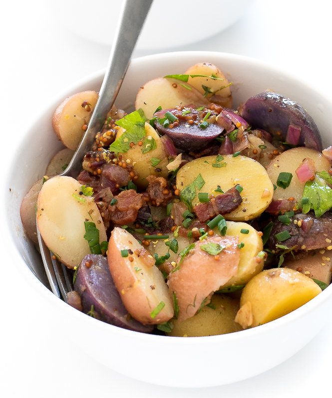 German Potato Salad Recipe in small white bowl with fork