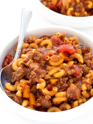 A white bowl filled with American goulash.
