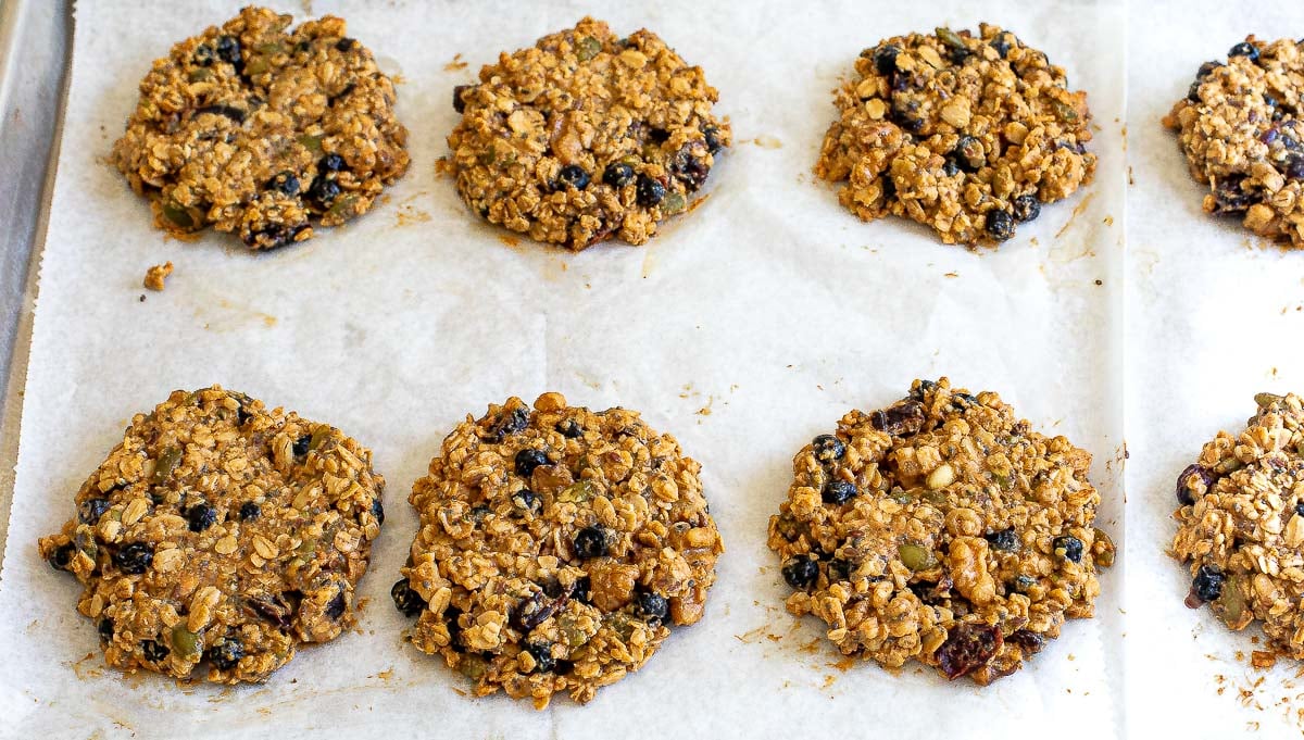 baked granola cookies on a sheet tray lined with parchment paper