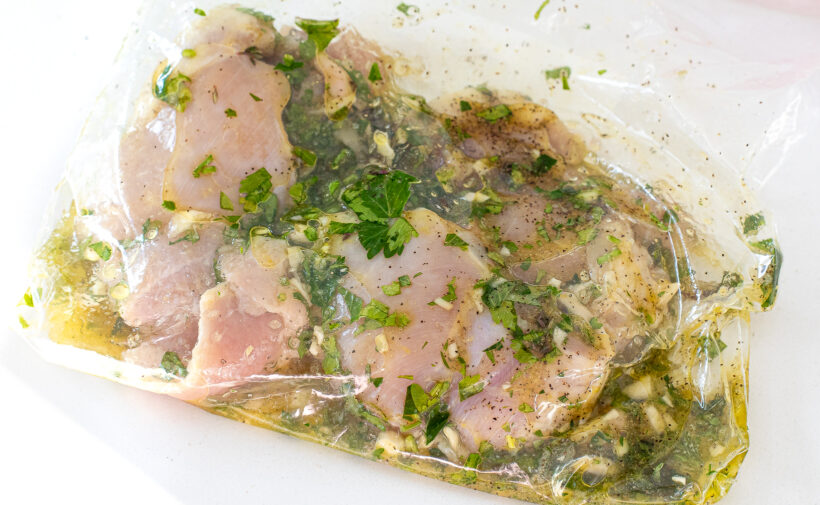 Chicken thighs after being marinated and still in the ziplock bag. 