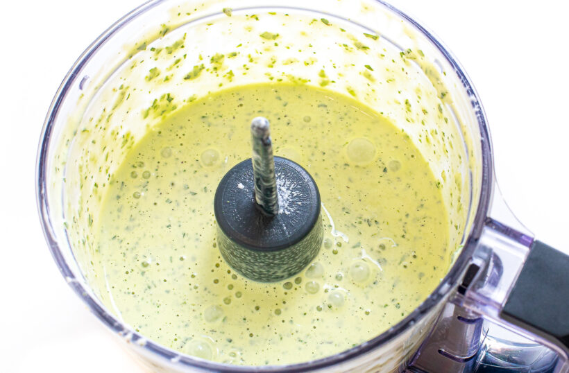 Green gooddess dressing blended in a food processor.
