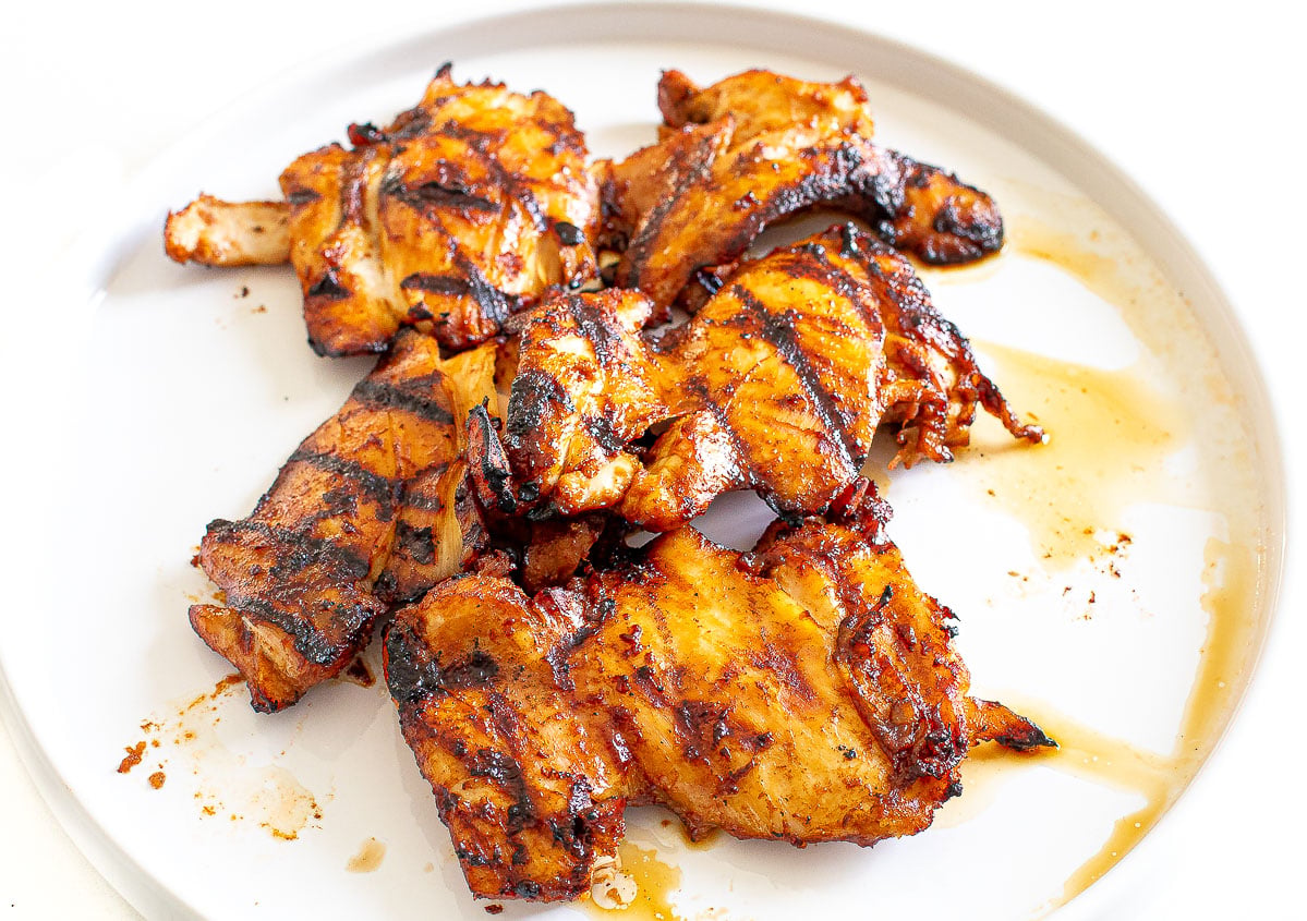 grilled asian chicken thighs resting on plate
