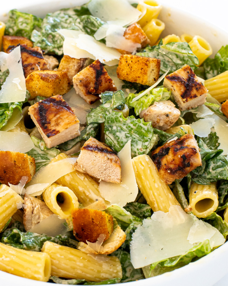 Caesar pasta salad in a white bowl.