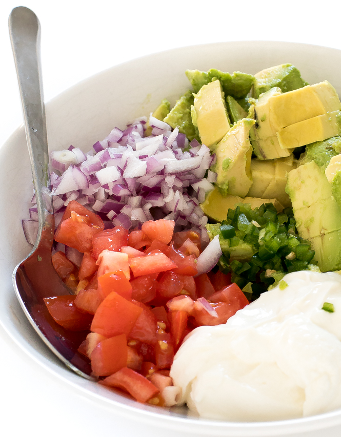 Guacamole ingredients in white bowl