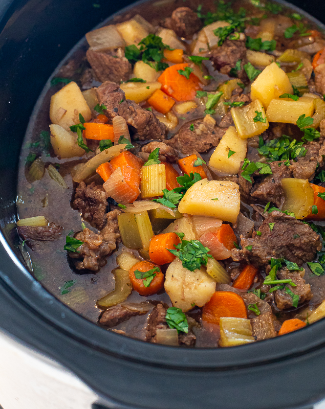 stew in crockpot topped with fresh chopped parsley