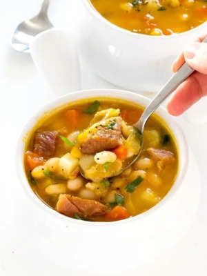 ham and bean soup in white bowl