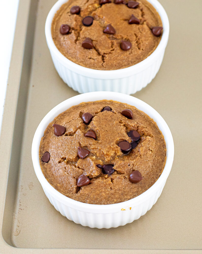 Two baked oats with chocolate chips on a sheet pan. 