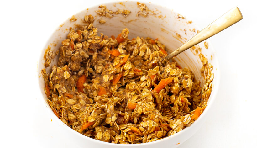 Carrot cake cookie oat mixture in a mixing bowl. 