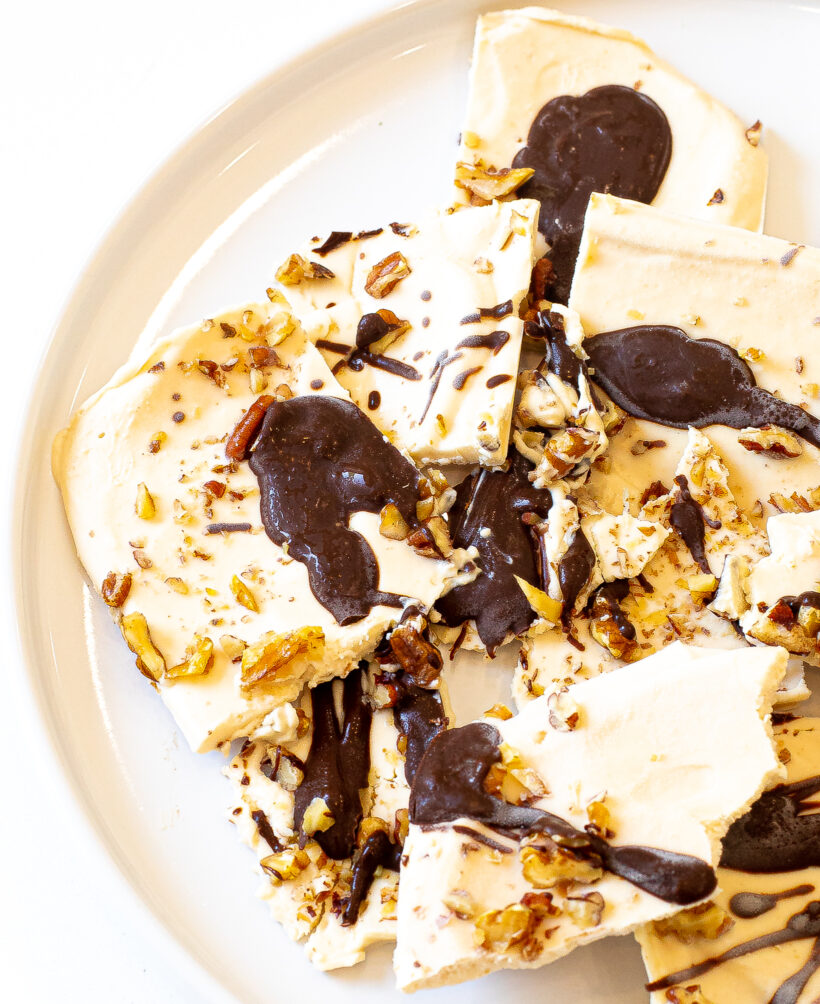Frozen cottage cheese bark cut into squares and served on a white plate.