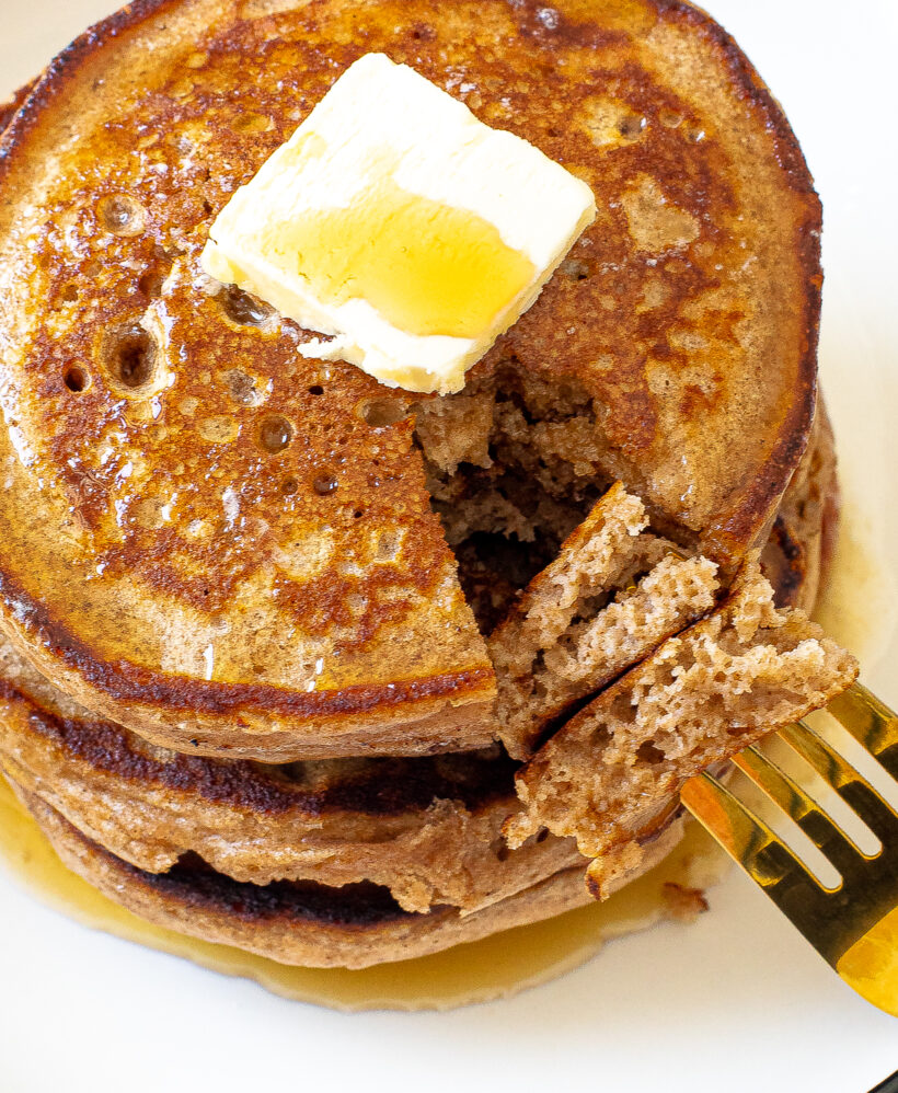 author taking a bite of pancakes