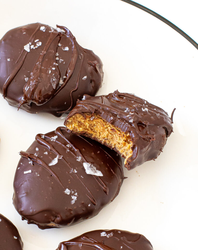 Close up view of peanut butter eggs with one with a bite taken out of it.