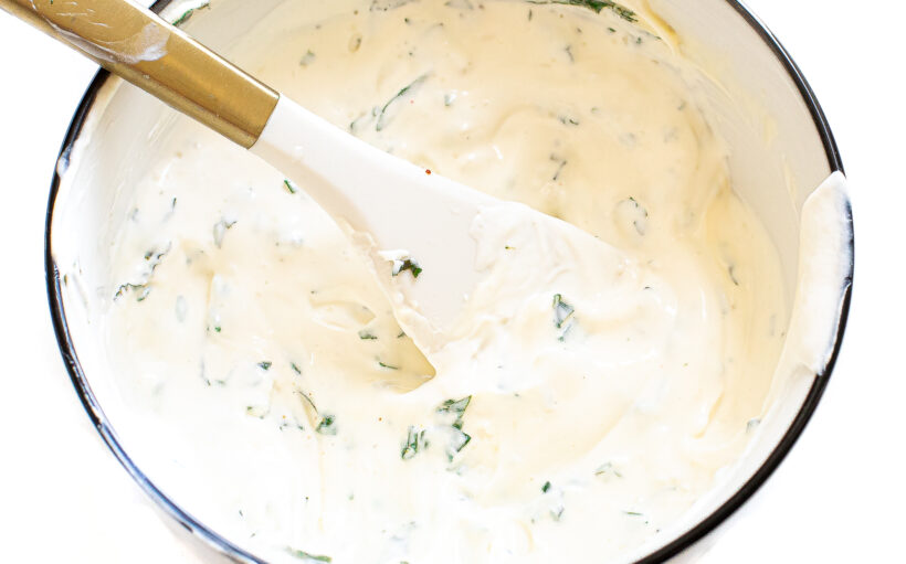 Sauce for zucchini fritters in a mixing bowl.