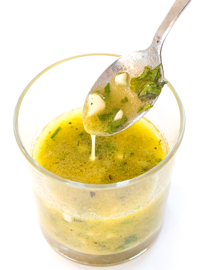 Lemon Vinaigrette in a clear glass with a spoon