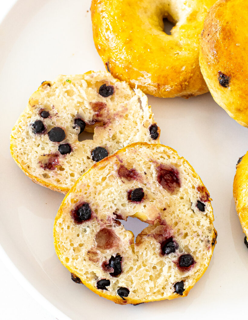 A blueberry bagel cut in half to show texture.