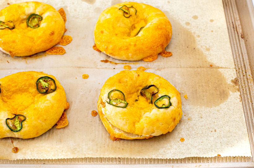Baked jalapeno bagels on a baking sheet.