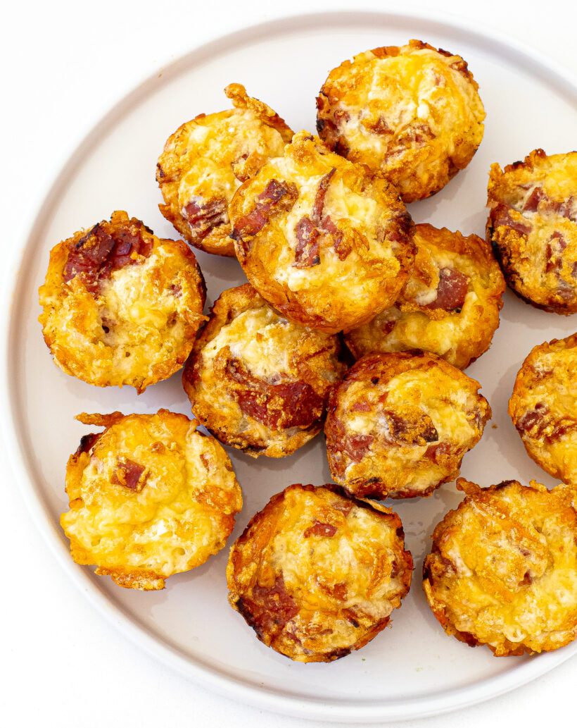 overhead shot of high protein pizza muffins on a white plate