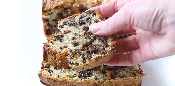 A hand holding chocolate chip pound cake.