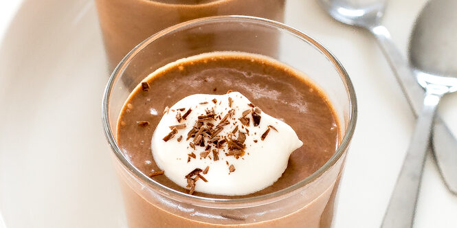 This 3-ingredient homemade chocolate mousse in two glasses topped with whipped cream and chocolate shavings | chefsavvy.com