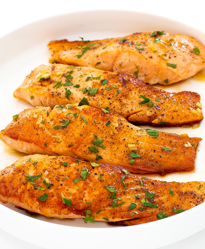 honey lemon garlic salmon topped with parsley on white serving tray