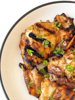 Honey lime chicken thighs on a plate.