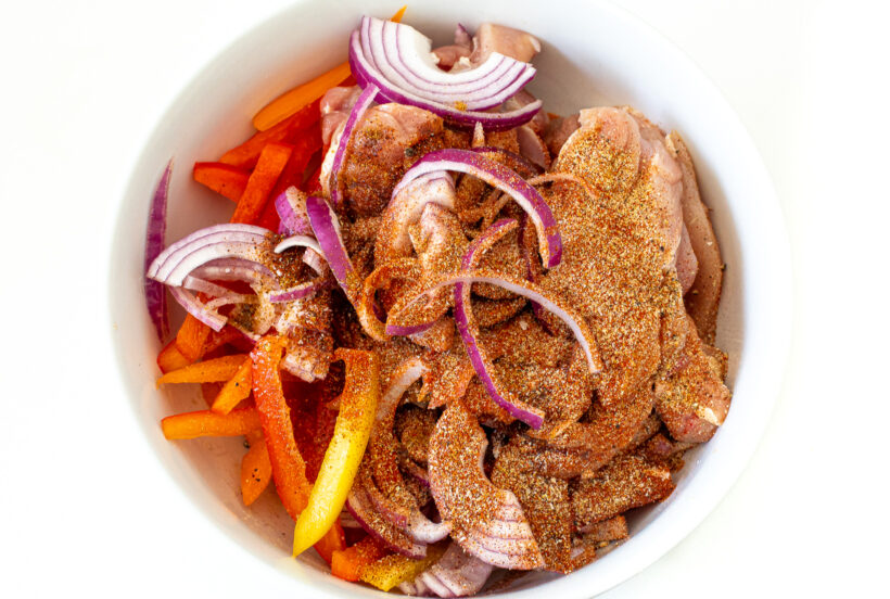 Mixing bowl with fajita ingredients.