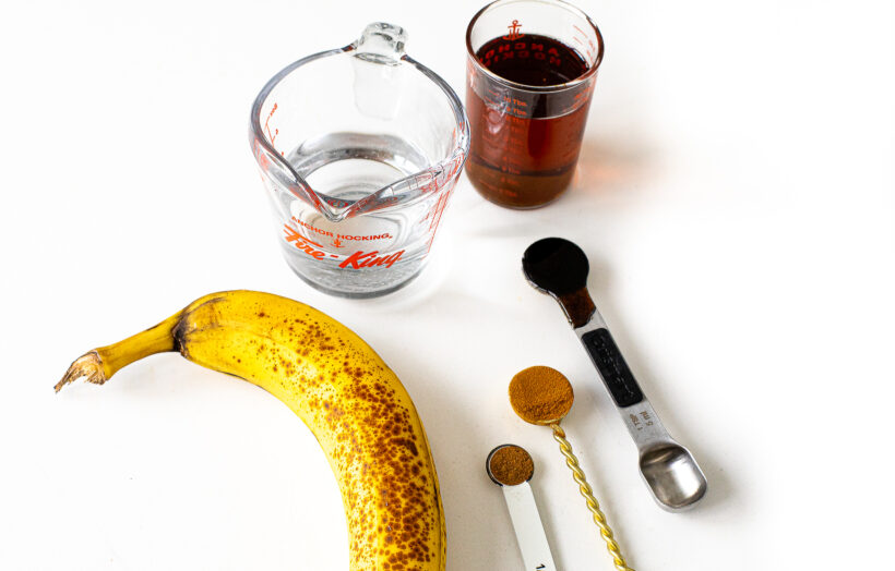 Banana bread latte ingredients laid out on a white surface.