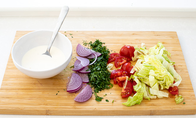 toppings for sandwiches on wooden cutting board