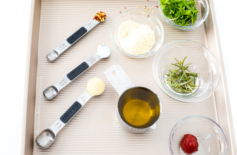 Ingredients for dipping oil laid out on a baking sheet.