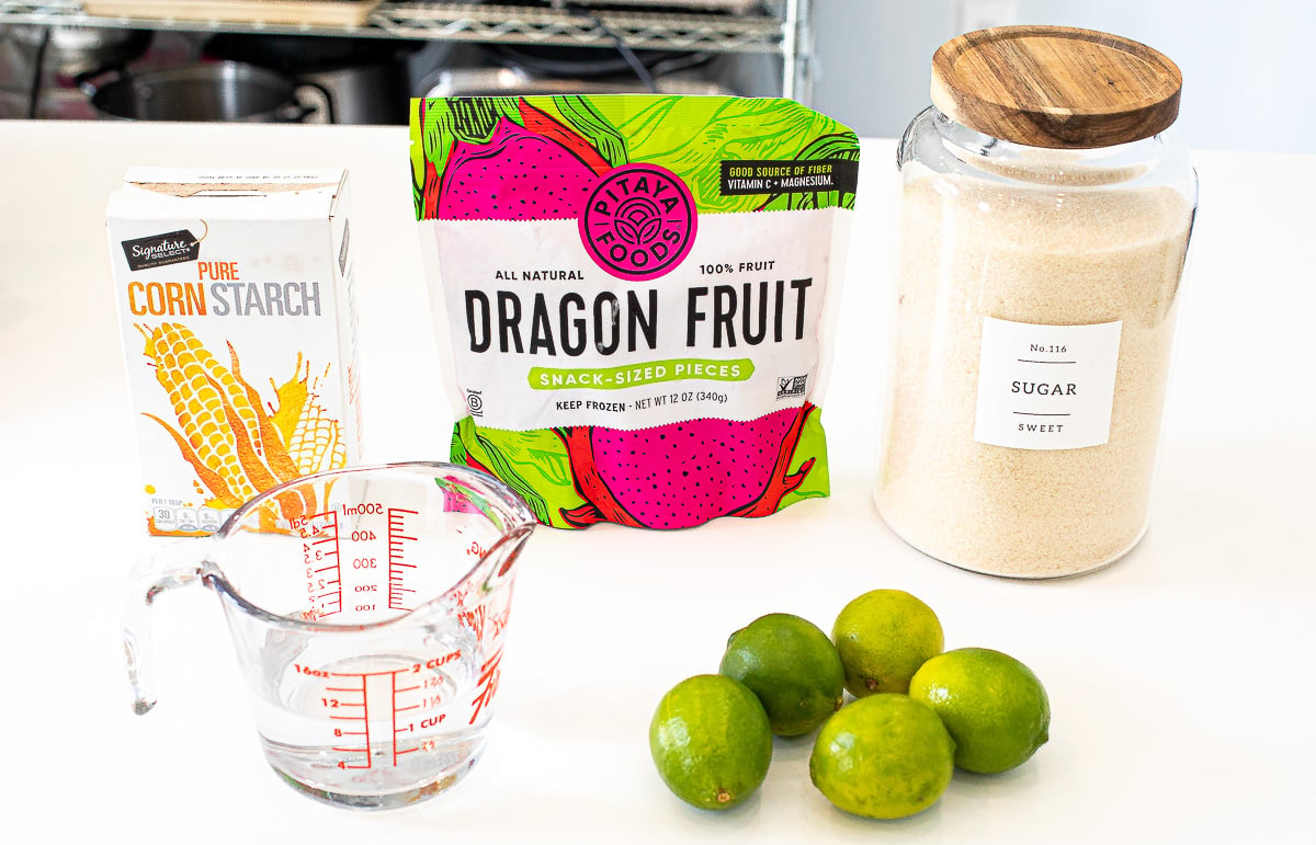 Frozen dragon fruit near fresh limes, water, sugar and cornstarch.