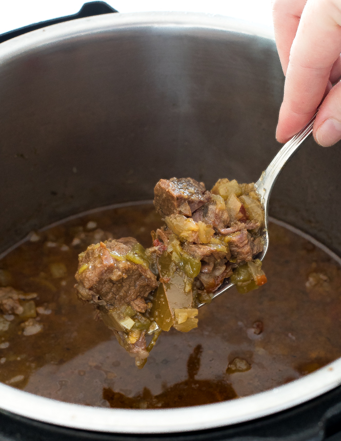 scooping shredded Barbacoa beef out of the Instant Pot